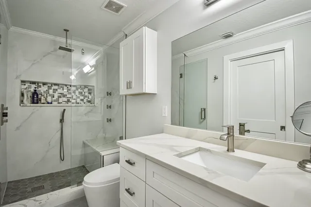 a bathroom with a sink toilet and shower