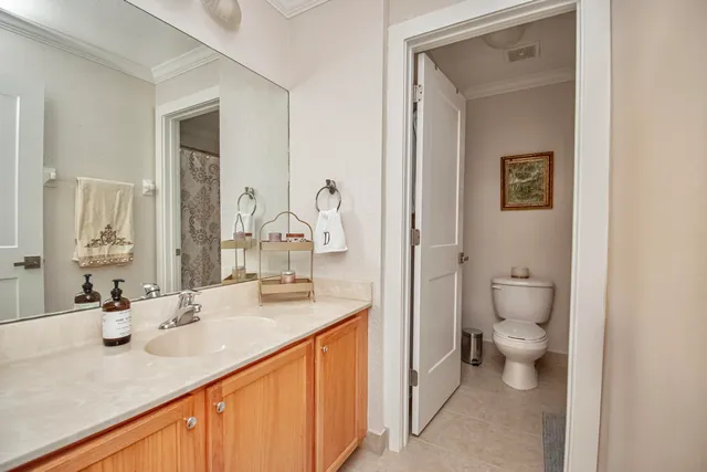 a bathroom with a sink a toilet and a mirror