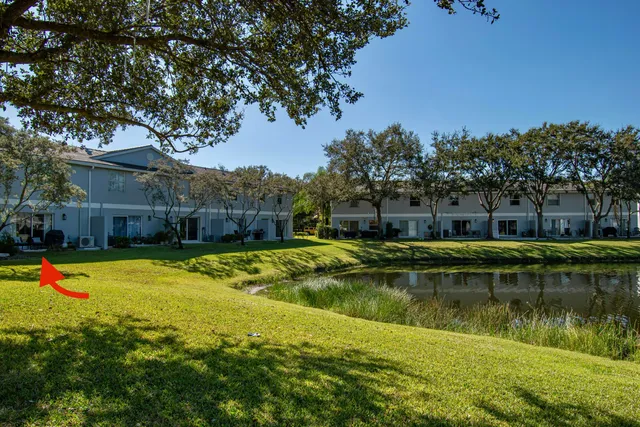 a view of a swimming pool with an outdoor seating and house in the background
