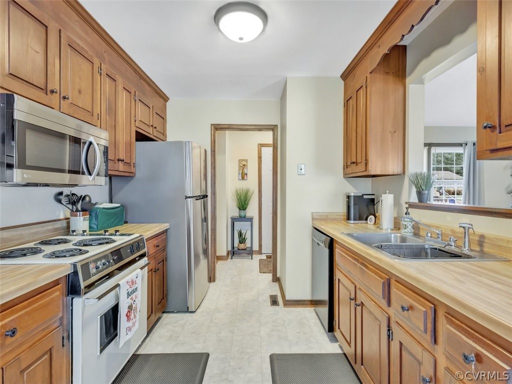 7713 Drexelbrook Road Chesterfield, VA 23832 - Photo 11 of 22 a kitchen with stainless steel appliances granite countertop a stove a sink dishwasher a refrigerator and a microwave