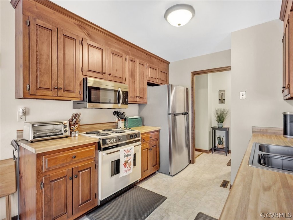 7713 Drexelbrook Road Chesterfield, VA 23832 - Photo 12 of 22 a kitchen with stainless steel appliances granite countertop a stove a refrigerator and a stove