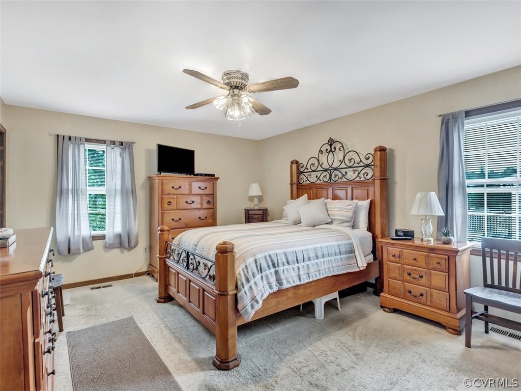 7713 Drexelbrook Road Chesterfield, VA 23832 - Photo 15 of 22 a bedroom with a bed and a table in it with wooden floor