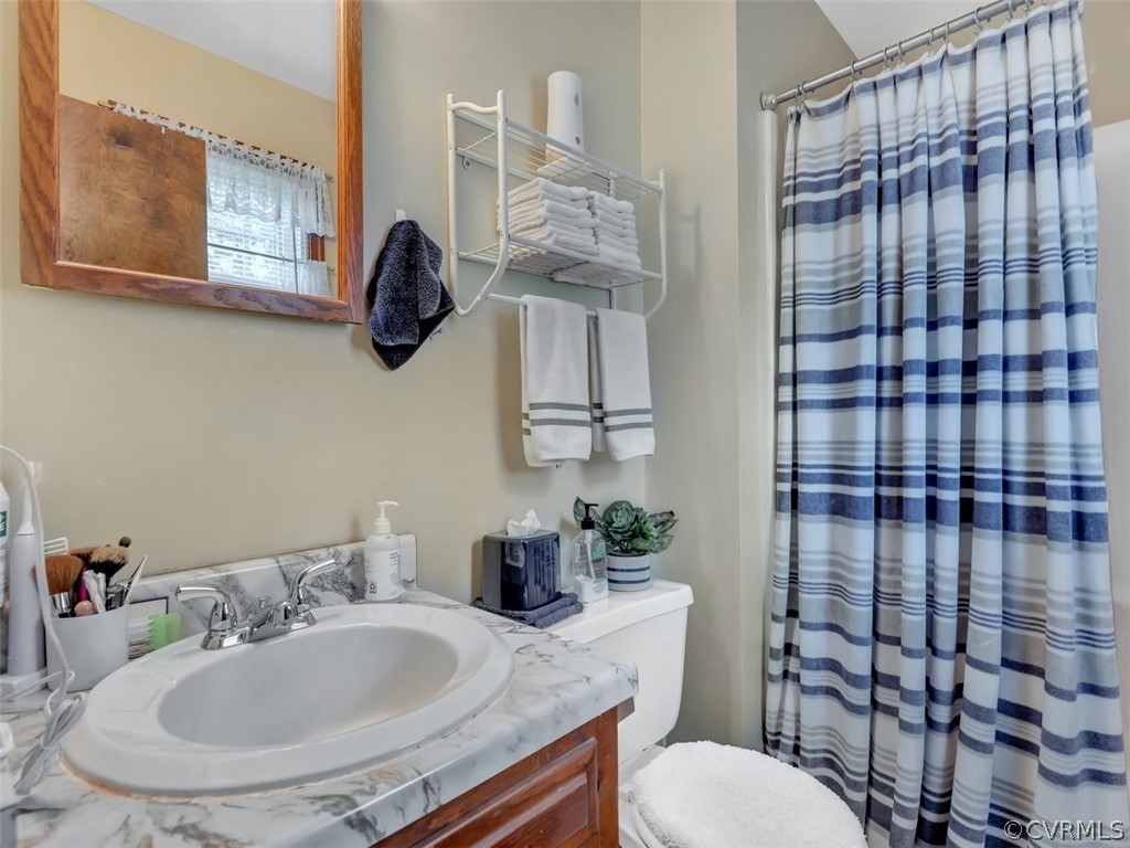 7713 Drexelbrook Road Chesterfield, VA 23832 - Photo 19 of 22 a bathroom with a sink toilet and shower