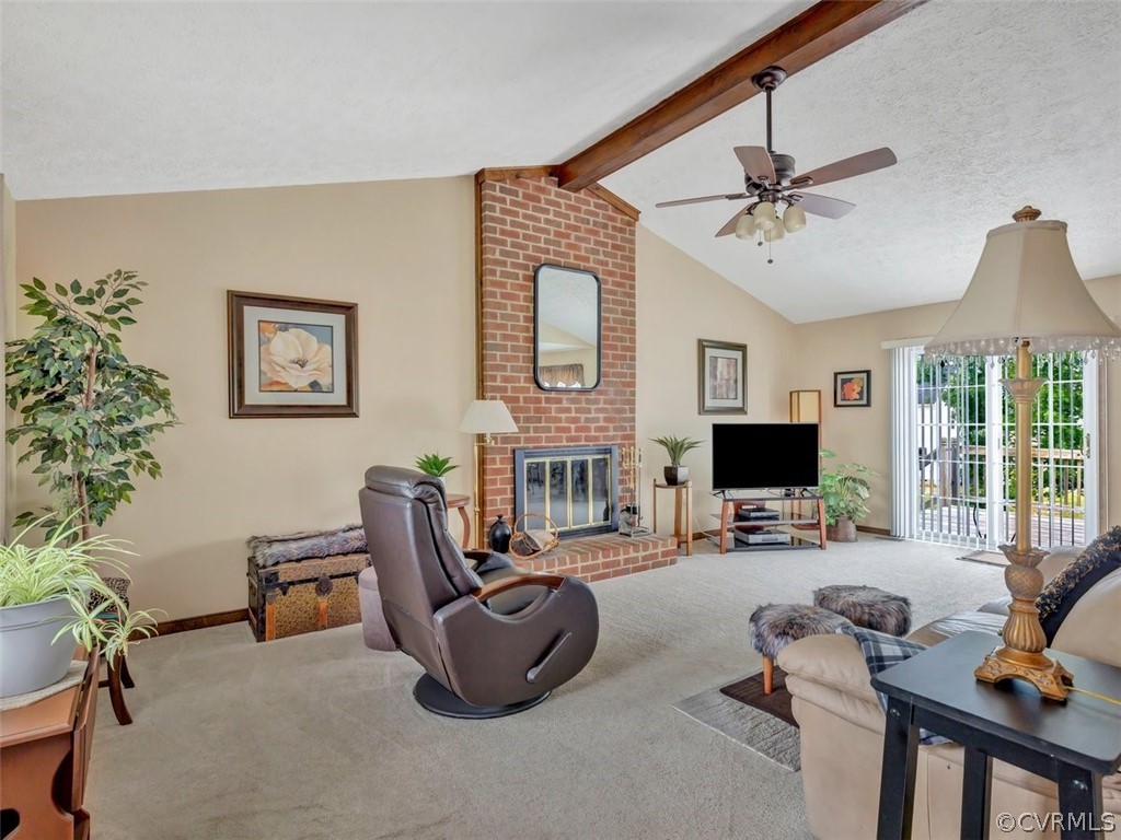 7713 Drexelbrook Road Chesterfield, VA 23832 - Photo 7 of 22 a living room with furniture a fireplace and a flat screen tv