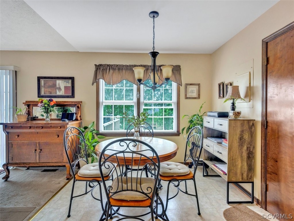 7713 Drexelbrook Road Chesterfield, VA 23832 - Photo 10 of 22 a dining room with furniture a chandelier and wooden floor