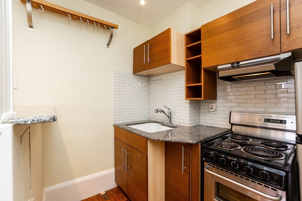 41 Worcester Square, Unit 5 Boston, MA 02118 - Photo 5 of 17 a kitchen with stainless steel appliances granite countertop a sink stove and refrigerator