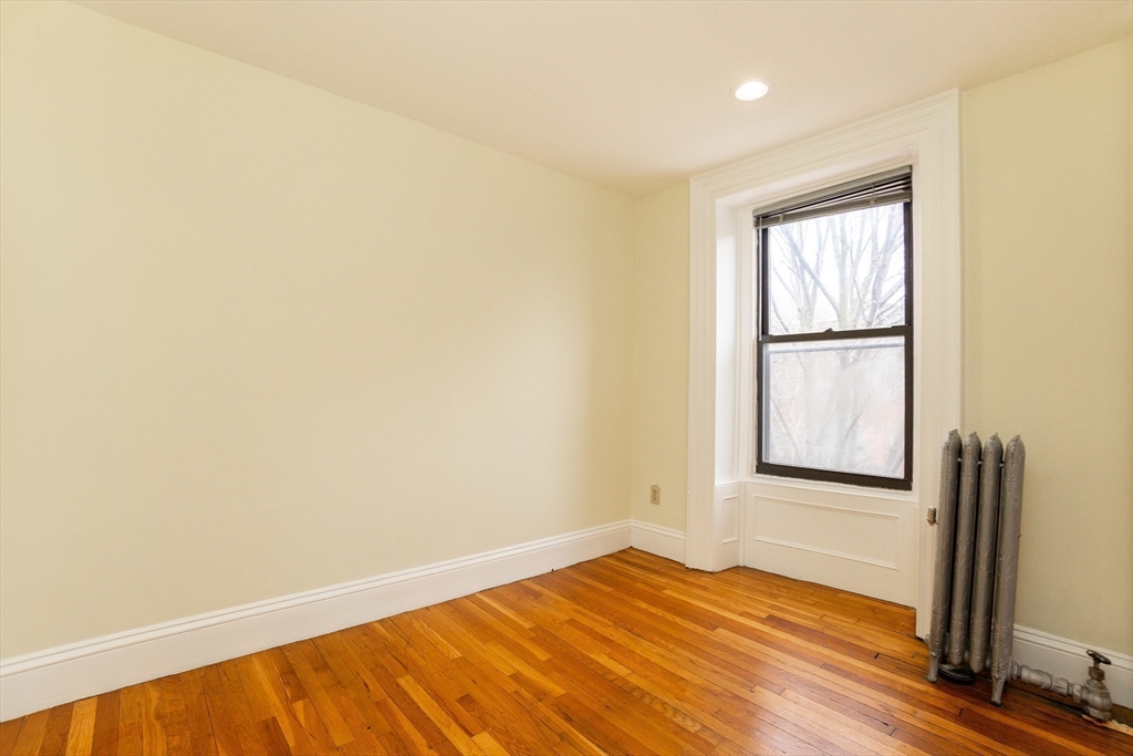41 Worcester Square, Unit 5 Boston, MA 02118 - Photo 10 of 17 an empty room with wooden floor and windows