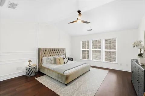 a spacious bedroom with a bed and a window