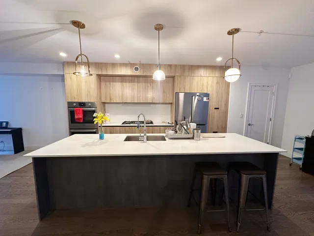a kitchen with kitchen island a sink stainless steel appliances and cabinets