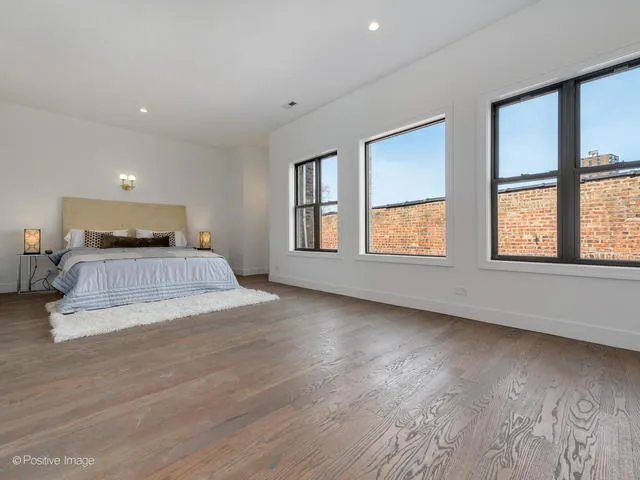 a bedroom with a large bed and a window