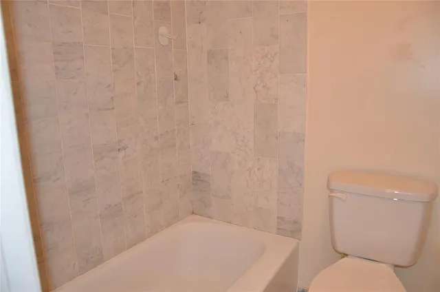 a bathroom with a toilet and a shower curtain