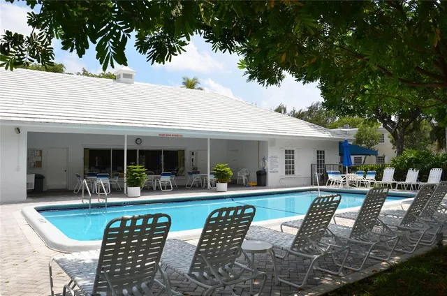 a room with pool table and windows