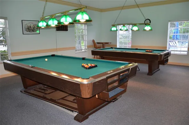 a view of a livingroom with furniture and a book shelf