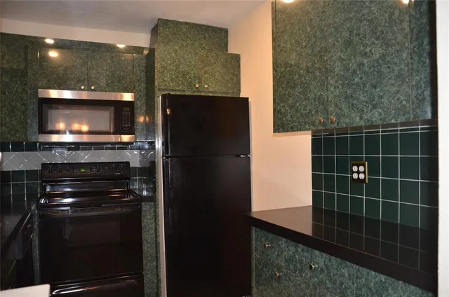 a kitchen with a refrigerator and cabinets