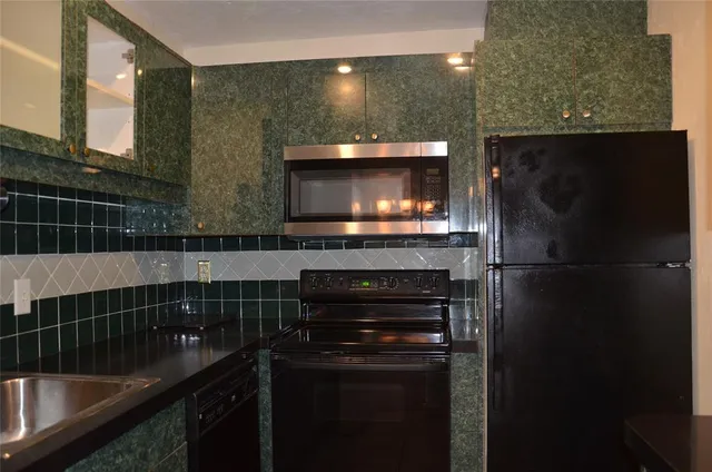 a kitchen with a refrigerator and a sink