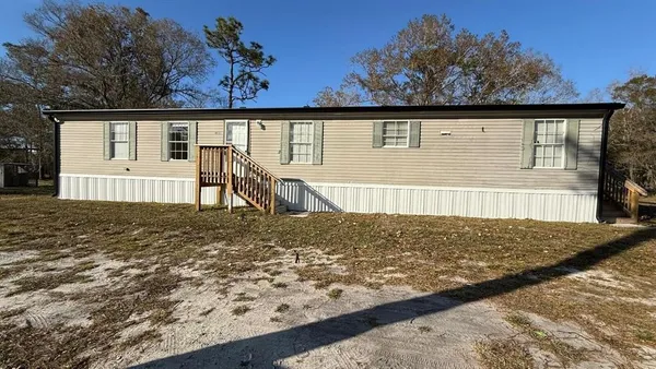 a view of a house with wooden fence