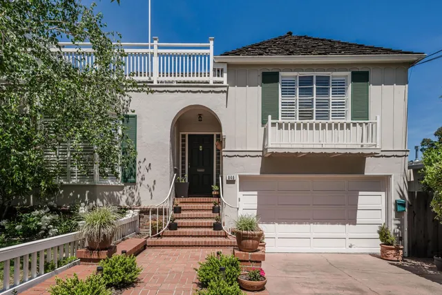 a front view of a house with a garden
