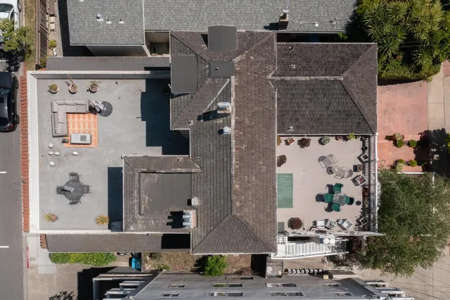 an aerial view of residential houses with outdoor space