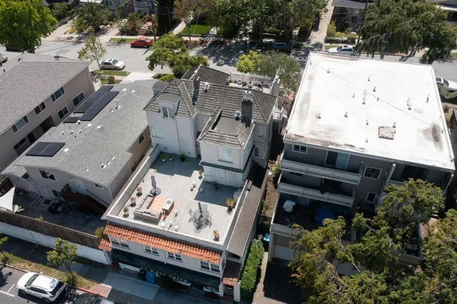 an aerial view of a house with a yard