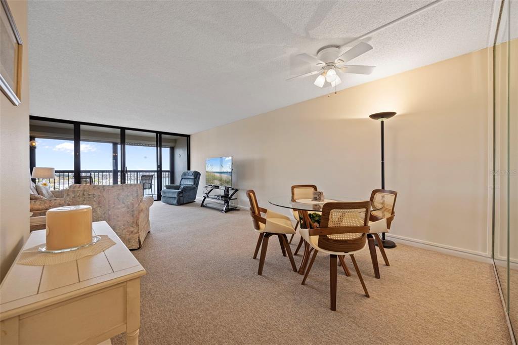 9425 Blind Pass Road, Unit 1006 St. Pete Beach, FL 33706 - Photo 12 of 45 a dining room with furniture and window