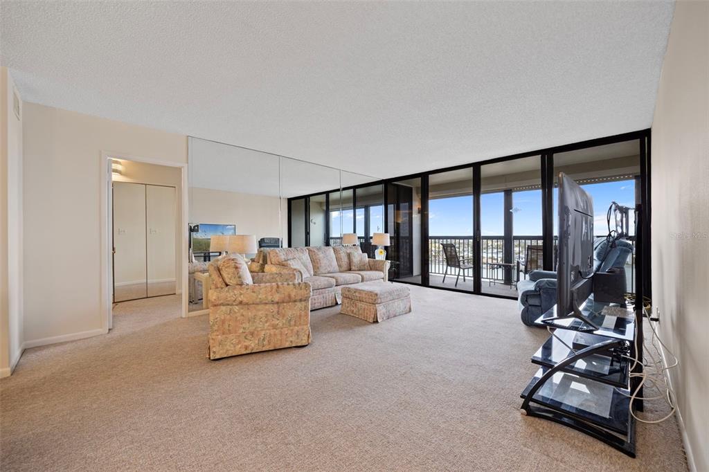 9425 Blind Pass Road, Unit 1006 St. Pete Beach, FL 33706 - Photo 14 of 45 a living room with furniture and a large window