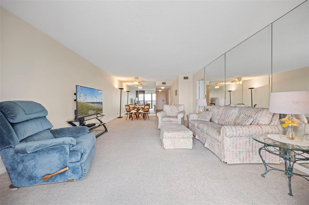 9425 Blind Pass Road, Unit 1006 St. Pete Beach, FL 33706 - Photo 18 of 45 a living room with furniture and a table