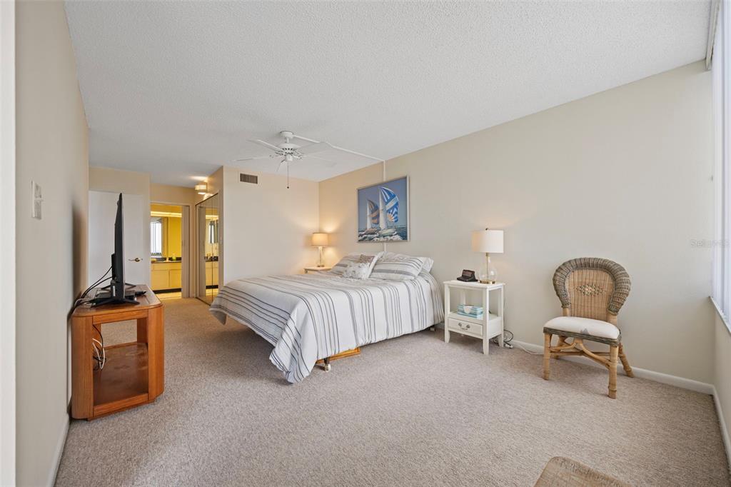 9425 Blind Pass Road, Unit 1006 St. Pete Beach, FL 33706 - Photo 20 of 45 a bedroom with a bed and dresser