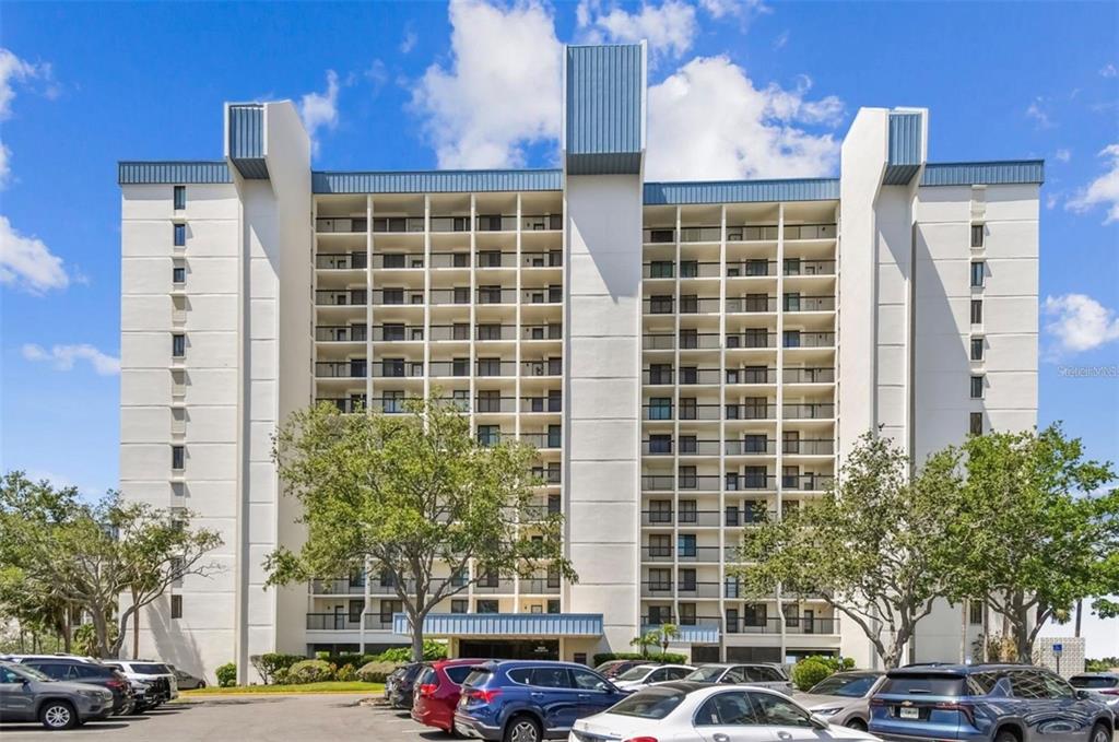9425 Blind Pass Road, Unit 1006 St. Pete Beach, FL 33706 - Photo 2 of 45 a couple of cars parked in front of a building