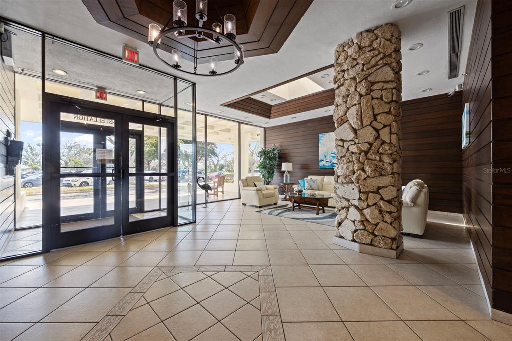 9425 Blind Pass Road, Unit 1006 St. Pete Beach, FL 33706 - Photo 31 of 45 a view of a entryway with furniture and floor to ceiling window