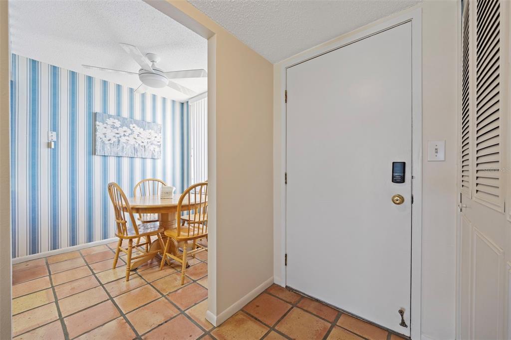 9425 Blind Pass Road, Unit 1006 St. Pete Beach, FL 33706 - Photo 5 of 45 a view of a dining room with furniture and window