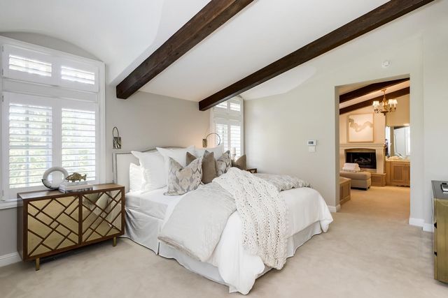 a spacious bedroom with a bed and a couch