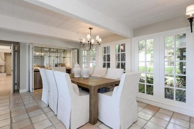 a dining hall with a dining table and chairs