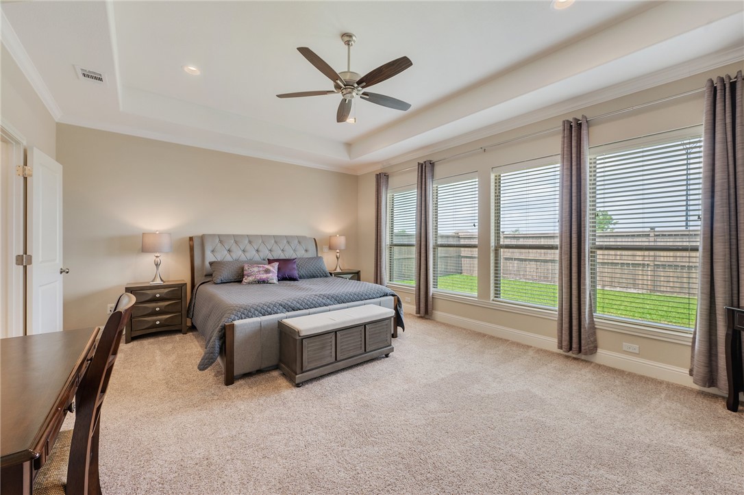 4261 Harding Way Bryan, TX 77802 - Photo 12 of 27 a spacious bedroom with a bed and a large window