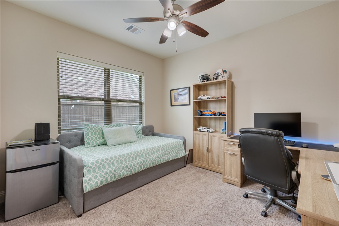 4261 Harding Way Bryan, TX 77802 - Photo 17 of 27 a bedroom with a bed desk and a window