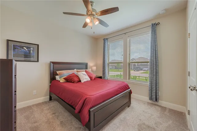 a bedroom with two beds and a window