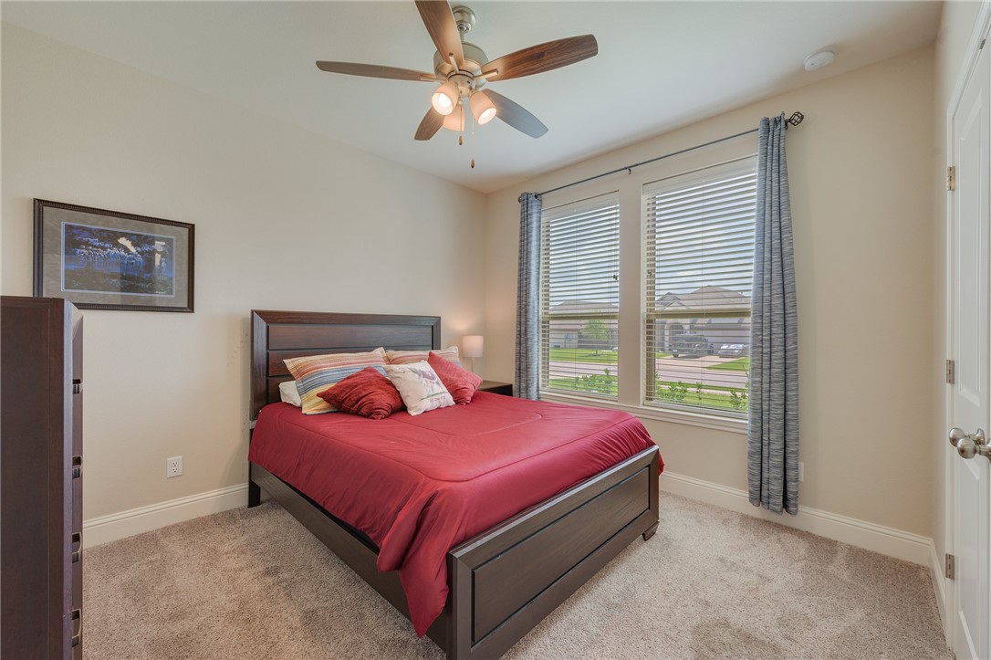 4261 Harding Way Bryan, TX 77802 - Photo 18 of 27 a bed sitting in a bedroom next to a window