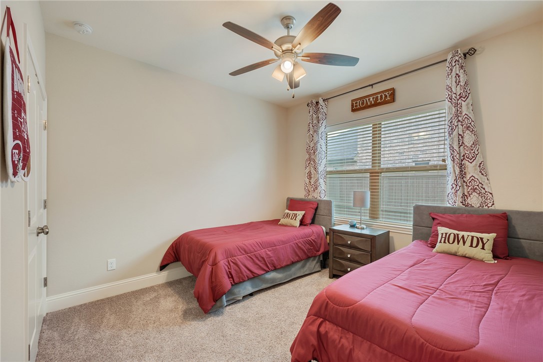 4261 Harding Way Bryan, TX 77802 - Photo 19 of 27 a bedroom with two beds and a window