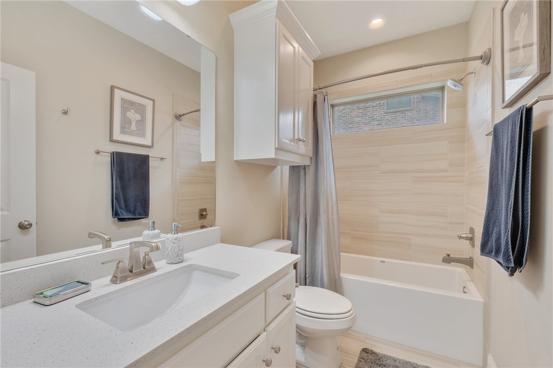4261 Harding Way Bryan, TX 77802 - Photo 20 of 27 a bathroom with a bathtub shower sink vanity and toilet