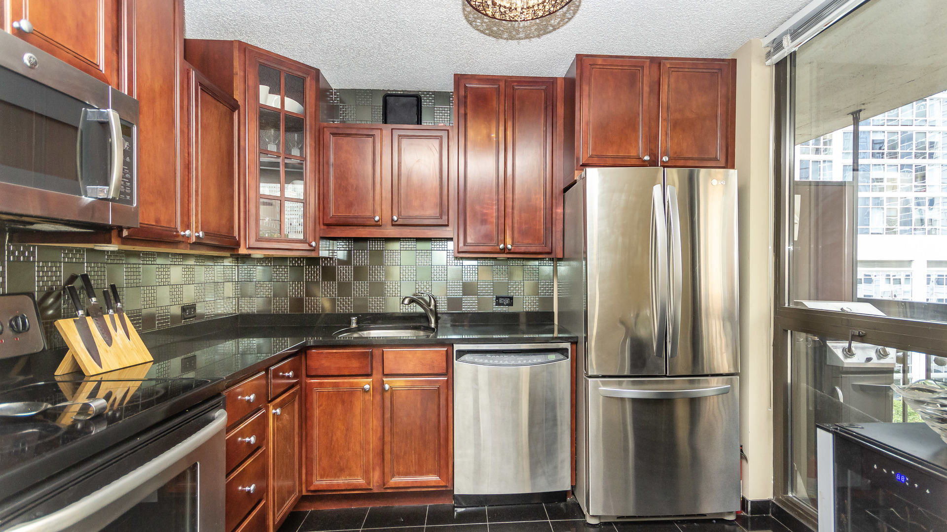 33 West Delaware Place, Unit 7A Chicago, IL 60610 - Photo 11 of 35 a kitchen with kitchen island a counter top space a sink and a refrigerator