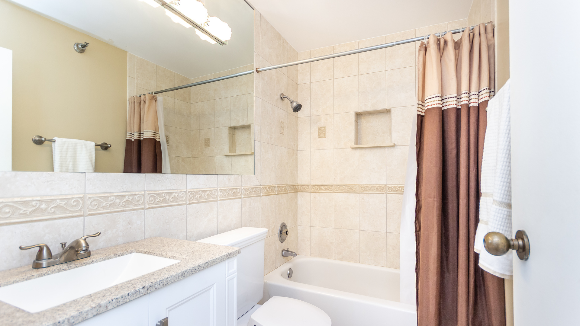 33 West Delaware Place, Unit 7A Chicago, IL 60610 - Photo 19 of 35 a bathroom with a granite countertop sink a toilet and shower