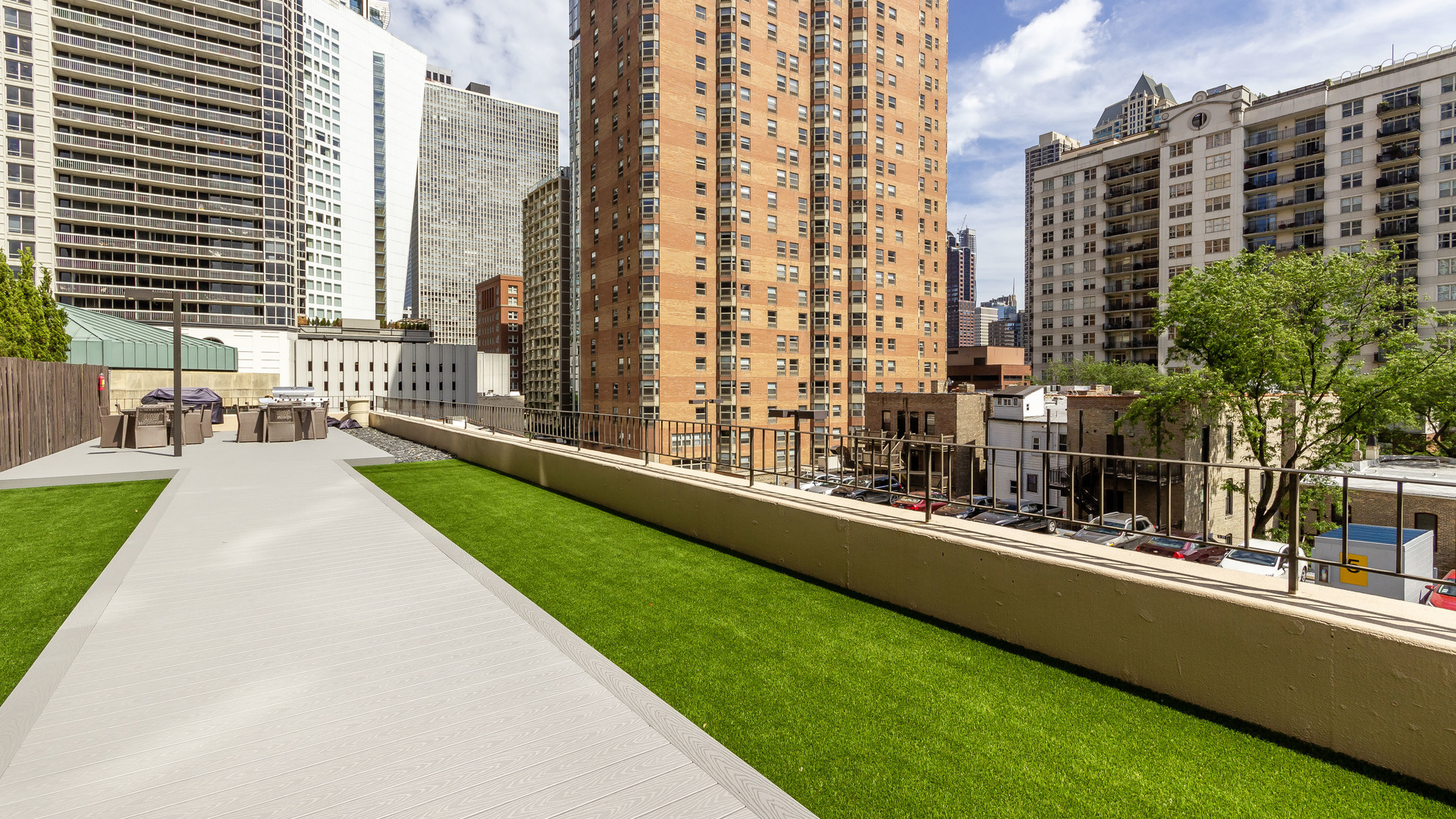 33 West Delaware Place, Unit 7A Chicago, IL 60610 - Photo 28 of 35 a view of balcony with a couple of cars parked in front of a house
