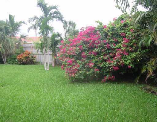 1249 Southwest 12th Avenue Boca Raton, FL 33486 - Photo 2 of 8 a view of a house with a big yard and a large tree