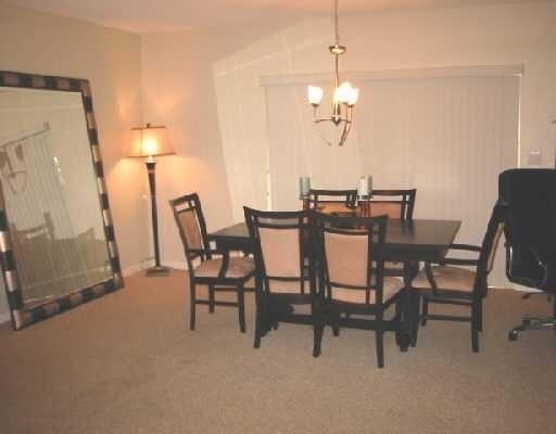 1249 Southwest 12th Avenue Boca Raton, FL 33486 - Photo 3 of 8 a view of a dining room with furniture and a chandelier