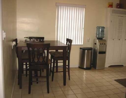 1249 Southwest 12th Avenue Boca Raton, FL 33486 - Photo 4 of 8 a dining room with furniture and window
