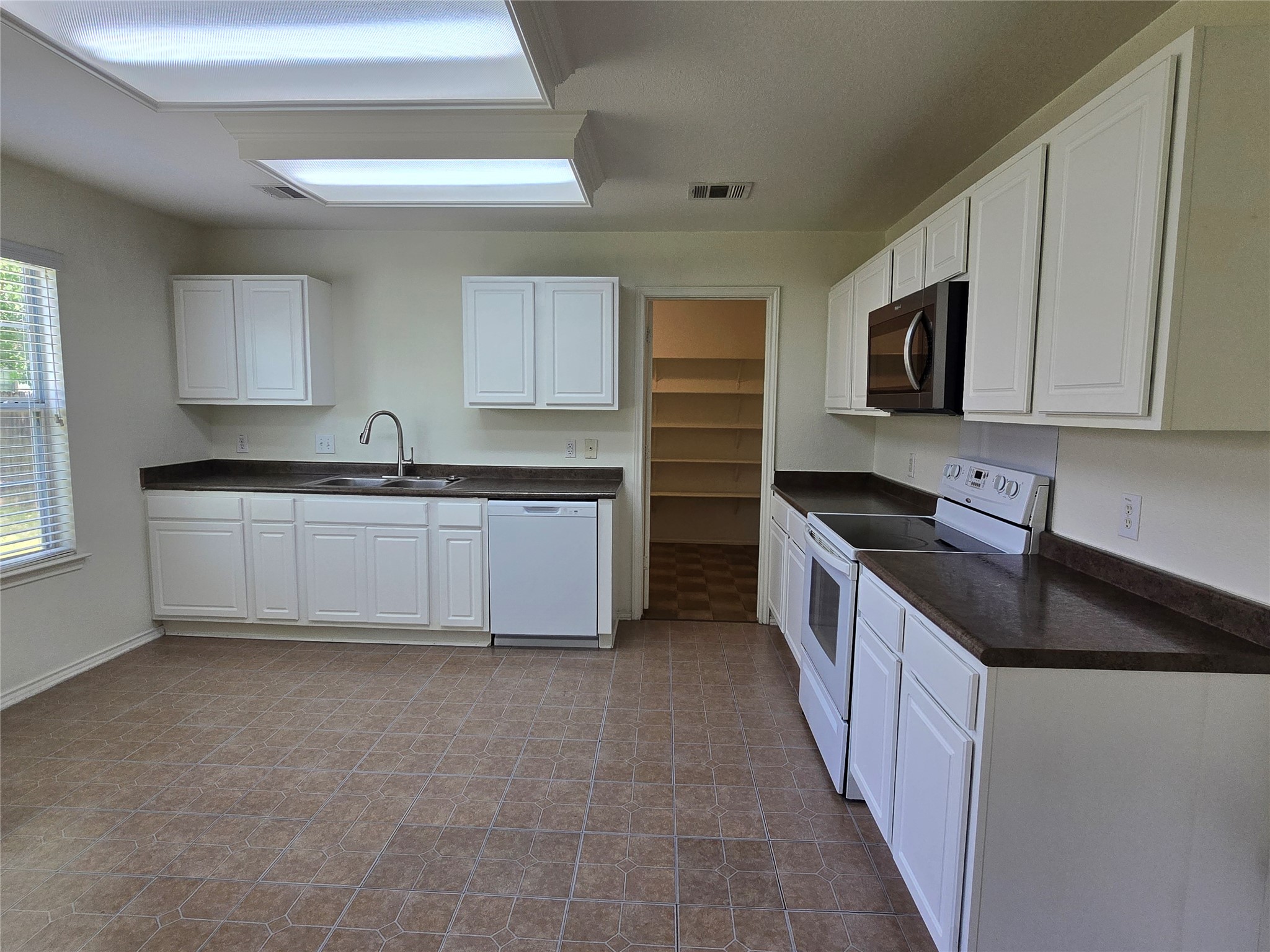 2021 Rim Rock Drive Leander, TX 78641 - Photo 3 of 14 A well-appointed kitchen offers functional appliances and ample storage space.