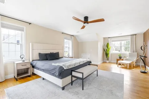 a bedroom with a bed a couch and a window