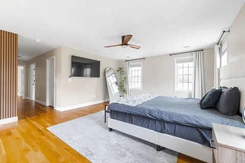 a bedroom with a large bed and a chandelier