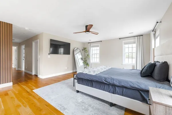 a bedroom with a large bed and a chandelier