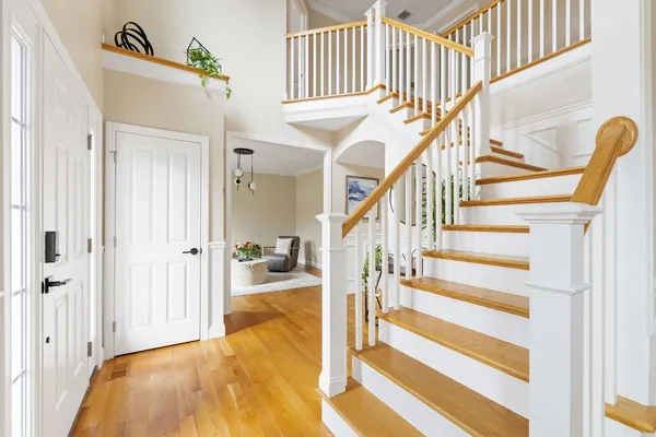 a view of entryway and hall with wooden floor