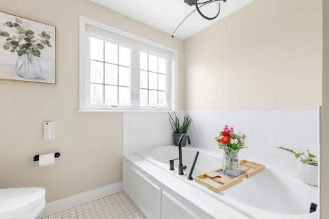 a bath tub sitting next to a white sink